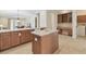 Open kitchen with island, breakfast bar, tile floor, and modern appliances offer a great space to cook and entertain at 20312 Heritage Point Dr, Tampa, FL 33647