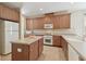 Well-lit kitchen featuring ample cabinet space, an island, and modern appliances at 20312 Heritage Point Dr, Tampa, FL 33647