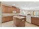 Spacious kitchen with wooden cabinetry, a center island, and modern appliances at 20312 Heritage Point Dr, Tampa, FL 33647