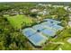 Aerial view of tennis courts within a lush community setting and well-maintained lawns at 20312 Heritage Point Dr, Tampa, FL 33647