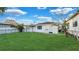 Backyard featuring a well-maintained lawn, full fence, and white exterior of the home at 2540 W Pine St, Tampa, FL 33607