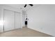 Bright bedroom with new flooring, ceiling fan, and a closet with sliding doors at 2540 W Pine St, Tampa, FL 33607