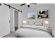 Cozy bedroom with natural light, closet with barn door, and soothing color palette at 2540 W Pine St, Tampa, FL 33607
