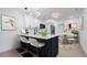 Stylish kitchen with stainless appliances, island with bar seating, and an adjacent dining area at 2540 W Pine St, Tampa, FL 33607