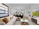 Bright, open living room featuring modern decor, hardwood floors and seamless flow into the kitchen at 2540 W Pine St, Tampa, FL 33607