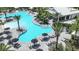 Resort-style pool with a Banana Bar, lounge chairs, umbrellas, and tropical landscaping at 26836 Dove Dr, Punta Gorda, FL 33955