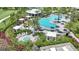 Resort-style pool and spa area featuring lounge seating, umbrellas, and lush landscaping at 26836 Dove Dr, Punta Gorda, FL 33955