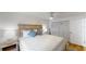 Comfortable bedroom features a neutral color palette, hardwood floors, and a spacious closet at 50 154Th Ave # 50, Madeira Beach, FL 33708