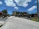 Charming street view of a quiet neighborhood with condominiums, lush trees, and street parking at 50 154Th Ave # 50, Madeira Beach, FL 33708
