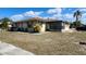 Charming single-story home with an enclosed patio and well-maintained landscaping at 5507 Riddle Rd, Holiday, FL 34690