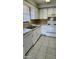 Well-lit kitchen with white cabinetry and modern countertops at 5507 Riddle Rd, Holiday, FL 34690