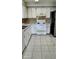 Functional kitchen with white cabinets and appliances at 5507 Riddle Rd, Holiday, FL 34690