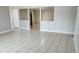 Open-concept living room features tile floors and modern design at 5507 Riddle Rd, Holiday, FL 34690