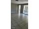 Spacious living room with tile floors and sliding glass doors at 5507 Riddle Rd, Holiday, FL 34690