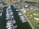 Aerial view showcasing a marina, community pool, golf course, and clubhouse in a beautiful waterfront setting at 5836 Skimmer Point S Blvd, Gulfport, FL 33707