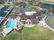 An aerial view showcases the clubhouse, pool, marina, and golf course at Pasadena Yacht & Country Club at 5836 Skimmer Point S Blvd, Gulfport, FL 33707