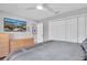 Relaxing bedroom showcases a mounted TV, ample closet space, and neutral decor for a serene environment at 5836 Skimmer Point S Blvd, Gulfport, FL 33707