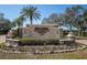 Inviting entrance to Pasadena Yacht & Country Club, featuring lush landscaping and a stately monument sign with water features at 5836 Skimmer Point S Blvd, Gulfport, FL 33707