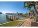 Dock on the harbor with easy access to the water, complemented by well-maintained landscaping and clear skies at 5836 Skimmer Point S Blvd, Gulfport, FL 33707