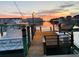A boat is docked on the inter coastal with a lovely sunset in the background at 5836 Skimmer Point S Blvd, Gulfport, FL 33707