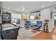 Bright game room featuring pinball machine, leather recliners, and hardwood floors at 5836 Skimmer Point S Blvd, Gulfport, FL 33707