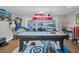 Entertaining game room with pool table, waterfront views, and arcade games at 5836 Skimmer Point S Blvd, Gulfport, FL 33707