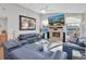Bright living room with fireplace, hardwood floors, and comfortable blue seating at 5836 Skimmer Point S Blvd, Gulfport, FL 33707