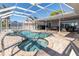 Enjoy a sparkling pool and spa in a screened enclosure, perfect for outdoor relaxation at 5836 Skimmer Point S Blvd, Gulfport, FL 33707