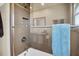 Modern shower showcases sleek tilework, a rainfall showerhead, and recessed shelving for a luxurious experience at 5836 Skimmer Point S Blvd, Gulfport, FL 33707
