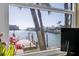 Picturesque water view from the home's window showcasing tropical landscaping, a dock, and clear blue water at 5836 Skimmer Point S Blvd, Gulfport, FL 33707