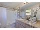 Bright bathroom featuring shower, vanity with sink, and neutral accents at 6273 Fallingleaf N Ct, Pinellas Park, FL 33782