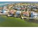 Aerial view of waterfront homes with private boat docks on the canal and bay at 727 Key Royale Dr, Holmes Beach, FL 34217