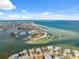 Gorgeous aerial shot of waterfront homes, a marina, and a beautiful stretch of beach at 727 Key Royale Dr, Holmes Beach, FL 34217