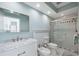Bright bathroom featuring marble countertop, a vessel sink, bidet and glass-enclosed shower at 727 Key Royale Dr, Holmes Beach, FL 34217