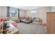 Bright bedroom with two twin beds, a window, and storage units with toys at 727 Key Royale Dr, Holmes Beach, FL 34217