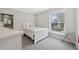 Bright bedroom with a white bed, and a window offering natural light and neighborhood views at 727 Key Royale Dr, Holmes Beach, FL 34217
