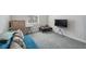 Cozy bedroom with a gray carpet, a television on a stand, and a small table with building blocks at 727 Key Royale Dr, Holmes Beach, FL 34217