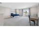 Large, well-lit bedroom featuring a balcony overlooking a view, bed, desk, and dual closets at 727 Key Royale Dr, Holmes Beach, FL 34217