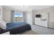 Bedroom with a queen bed, dresser with TV, access to a balcony, and gray carpet at 727 Key Royale Dr, Holmes Beach, FL 34217