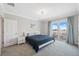 Well-lit bedroom features a queen bed with a balcony overlooking the scenic outdoors at 727 Key Royale Dr, Holmes Beach, FL 34217