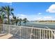 Expansive deck with stunning water views and lush tropical foliage, offering a serene outdoor space at 727 Key Royale Dr, Holmes Beach, FL 34217