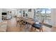 Elegant dining area with hardwood floors, a large wooden table, and sliding doors to the lanai at 727 Key Royale Dr, Holmes Beach, FL 34217