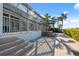 Dock with a stone bench and waterfront area, with lush landscaping at 727 Key Royale Dr, Holmes Beach, FL 34217