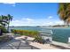 Wooden dock and waterfront area with lush landscaping, perfect for boating enthusiasts at 727 Key Royale Dr, Holmes Beach, FL 34217