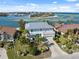 Aerial view of a white two-story home showcasing its lush landscaping and waterfront views at 727 Key Royale Dr, Holmes Beach, FL 34217