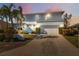 Charming two-story home with landscaped yard, two-car garage, and balcony at 727 Key Royale Dr, Holmes Beach, FL 34217