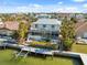 Aerial shot of waterfront home with a screened lanai, pool, dock, and meticulous landscaping at 727 Key Royale Dr, Holmes Beach, FL 34217