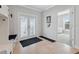 Bright foyer with tiled floors, storage, and double glass doors leading inside at 727 Key Royale Dr, Holmes Beach, FL 34217