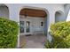 Inviting front porch featuring tiled floors, a wood ceiling, a bench, and lush greenery at 727 Key Royale Dr, Holmes Beach, FL 34217