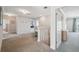 Upstairs hallway leading to bedrooms, featuring neutral carpeting and white trim at 727 Key Royale Dr, Holmes Beach, FL 34217